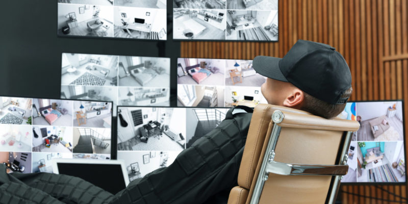 tired-security-guard-sleeping-at-workplace-in-office-168315944